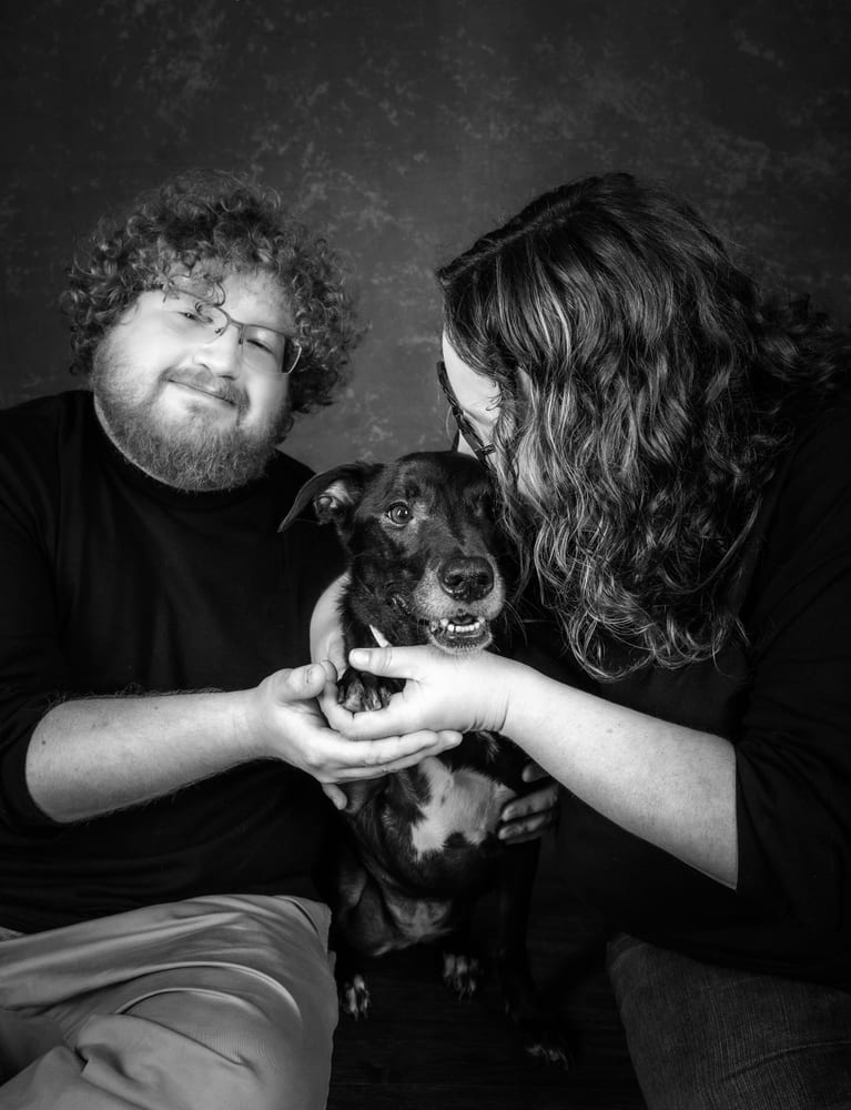 Lauren and her partner close together with their dog